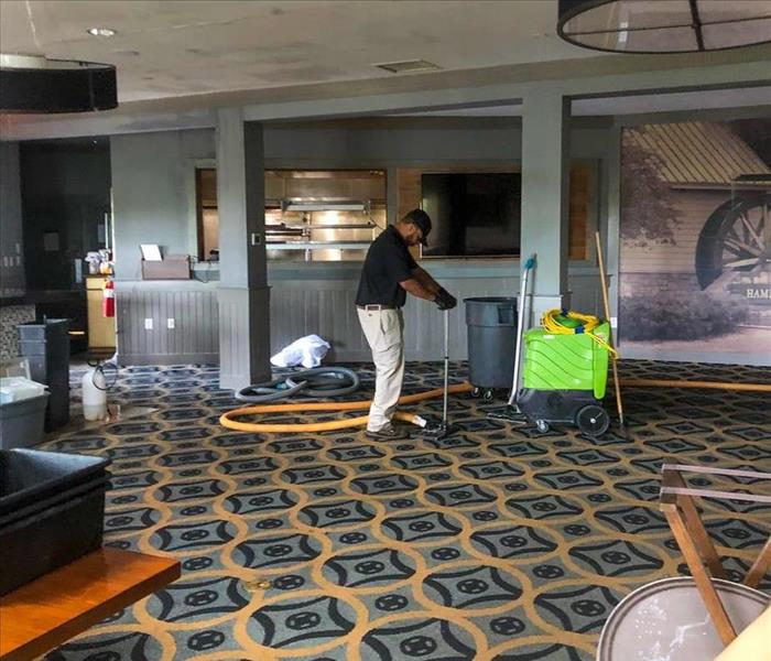 SERVPRO tech extracting water from a carpet in and Atlanta, GA business
