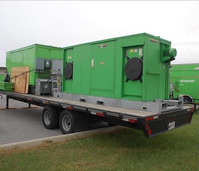 Large commercial equipment standing outside.