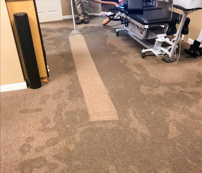 Extracting water from carpet.