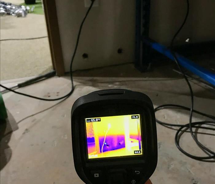 SERVPRO tech using a moisture meter in Atlanta, GA.