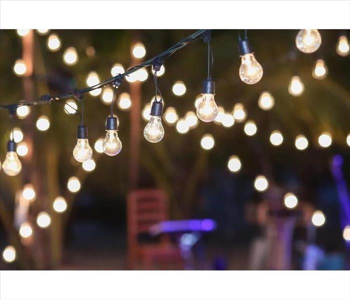 outdoor string lights hanging on a line in backyard